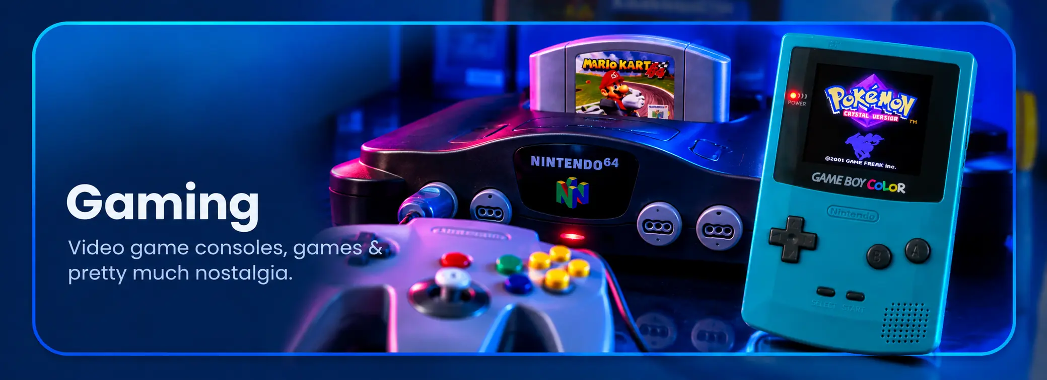 Gaming — Nintendo 64 with Mario Kart 64 inserted and teal Game Boy Color displaying Pokémon Crystal